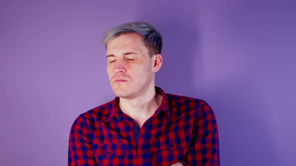 Close Up of Young Man Getting Slapped in Face on Purple Background