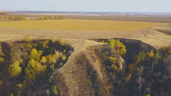 Steep Ravines with Grass Woods and Couple on Crest Aerial