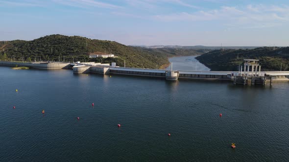 Drone flying over Alqueva dam with river in background, Portugal. Aerial forward