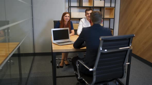 The Male and Female Talking with Lawyer in Bank Boardroom