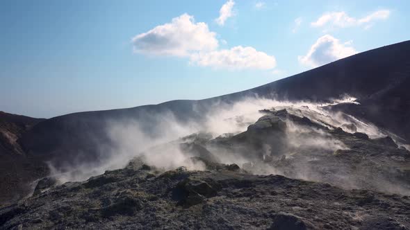 Hot Volcanic Gas Exiting Through Fumaroles on Vulcano Island. Steaming Surface of Volcano. Blue Sky