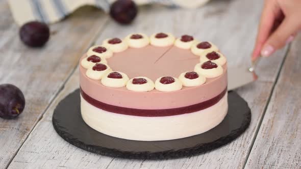 Delicious plum mousse cake with whipped cream and jelly