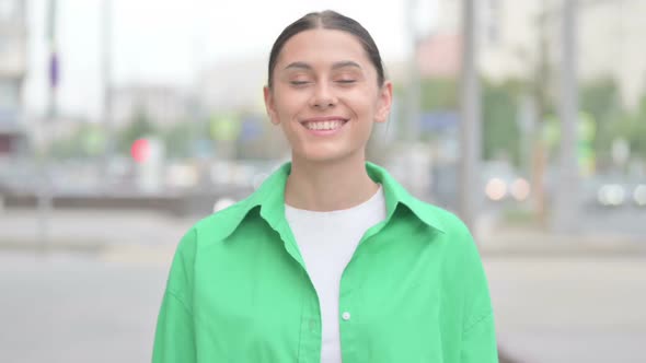 Agree Hispanic Woman Shaking Head in Approval Outdoor