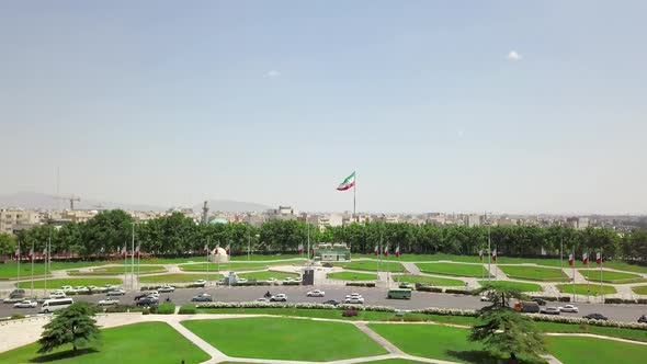 Aerial drone view of the city near Azadi tower in Tehran.View of waving Iranian flag.Iran 2018,may