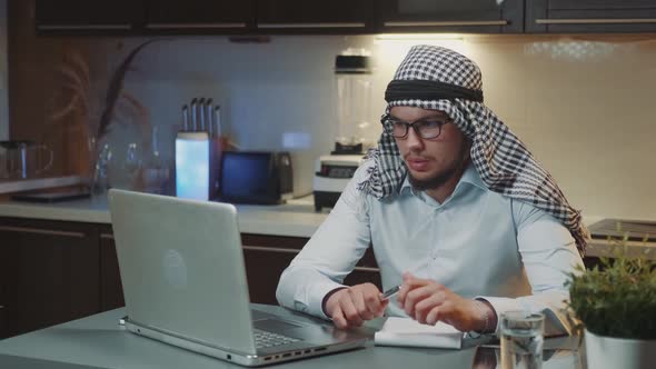 Arabic Man with Kandora Making Video Call on Computer Working From Homeoffice