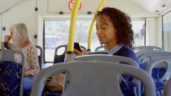 Commuters using and talking on mobile phone while travelling in bus 4k
