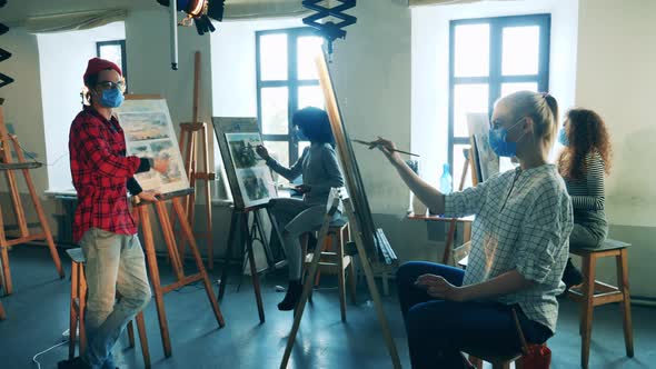 Art School with a Teacher in a Face Mask Holding a Painting Class