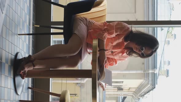 Female Reading Book While Sitting in Cafe