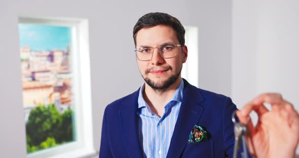 Close Up Portrait of Happy Handsome Young Caucasian Male Real Estate Agency Worker in Suit