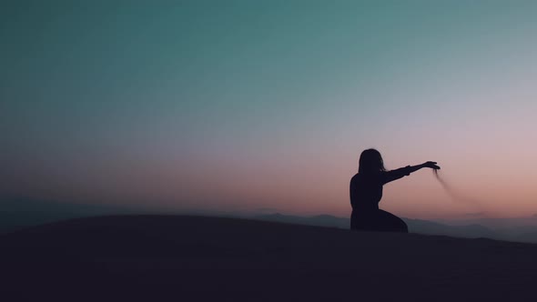 Thoughtful Woman Sit In Desert At Dusk