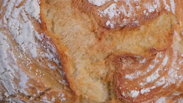 Background of Rotating Ruddy Fresh White Bread Top View Closeup