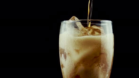 Cola Bubbles Into Glass With Ice