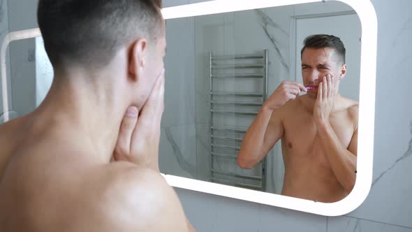 Young Man Brushing His Teeth Bathroom Stop Becuse Tooth Pain