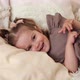 Happy Child Lies on the Bed and Laughs - VideoHive Item for Sale