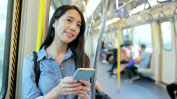 Woman use of mobile phone on train 