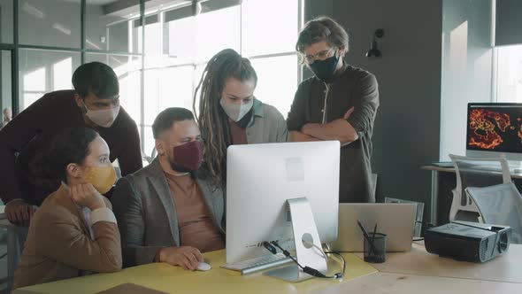 Team of Businesspeople in Face Masks Brainstorming