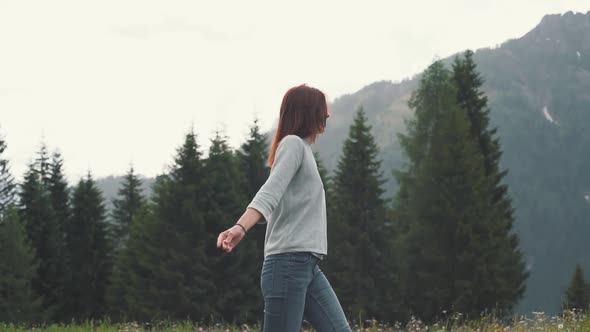 Slow Motion Shot of Happy Young Woman Spinning and Running in the Dolomites Northern Italy in the