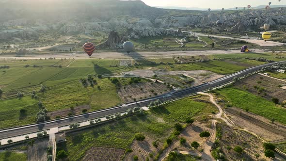 4K Aerial view of Goreme. Colorful hot air balloons fly over the valleys.