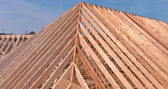 Newly Built Wooden Skeleton Frame of House Roof Section