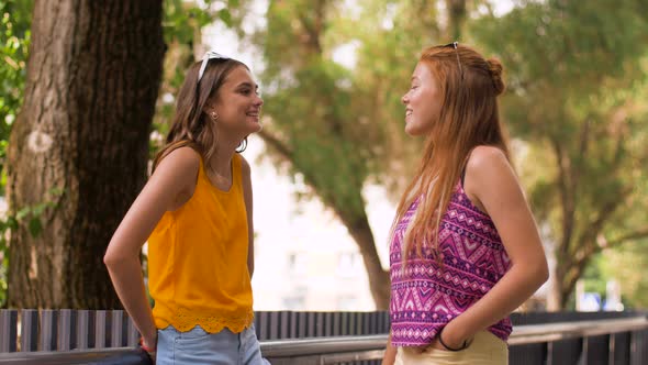 Teenage Girls or Friends Talking in Summer Park