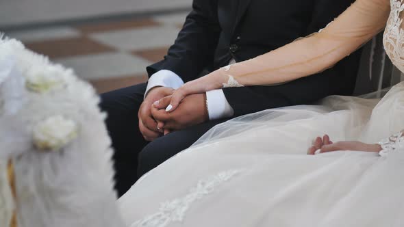 The Hands of the Newlyweds Are Joined Together at a Catholic Wedding Ceremony in the Church.
