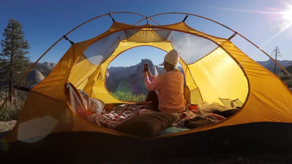 The Tourist Shoot with a Smartphone the View of the Half Dome Cliff Through the Window in the Tent.