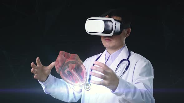 Male Doctor Using VR Glasses Virtual Reality Working On 3D Human Heart