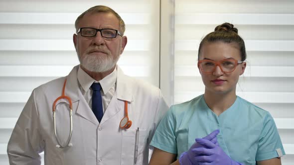 Portrait of an Elderly Male Doctor and a Young Female Nurse