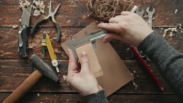 Experienced Carpenter in Work Clothes and Small Buiness Owner Is Carving a Wooden Board Design