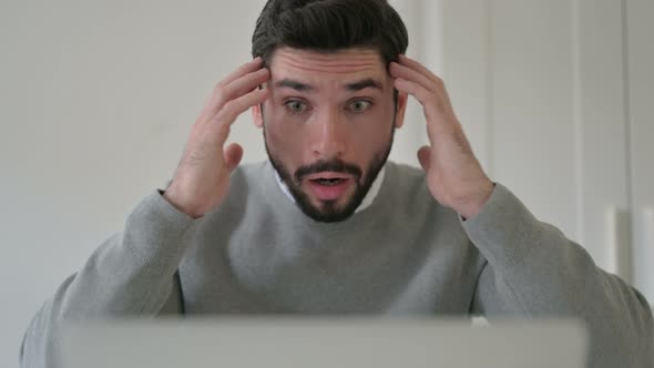 Close Up of Man Feeling Shocked While Using Laptop