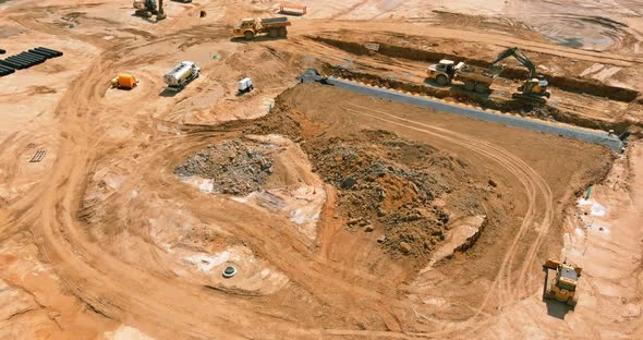 Aerial View of Large Construction Site with Several Crawler Excavator Machines in Moving Earth It