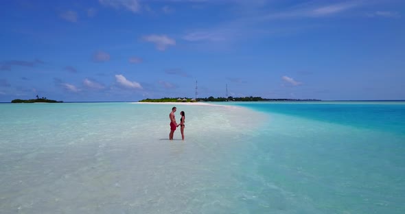 Beautiful lady and man after marriage in love have fun on beach on summer white sandy background 