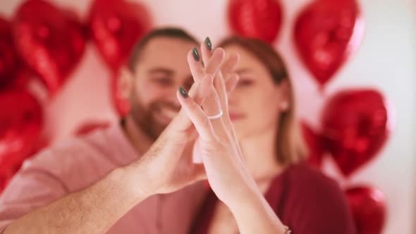 Close Up Portrait Happy Couple Faces Looking Through Fingers Making Heart Shape