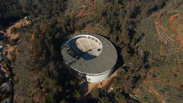 Aerial top down orbit over Quinta Vergara Amphitheater and Park surrounded by forest in hillside, Vi