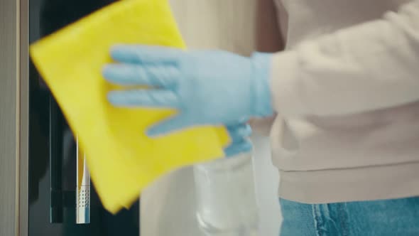 Closeup of Woman Hands Using a Sanitizer and a Wet Towel for Disinfection Doors Knob