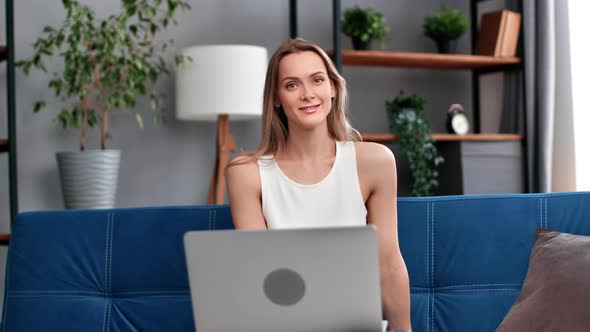 Portrait Happy Beautiful Woman Sitting on Couch in Front of Laptop Relaxing with Positive Emotion