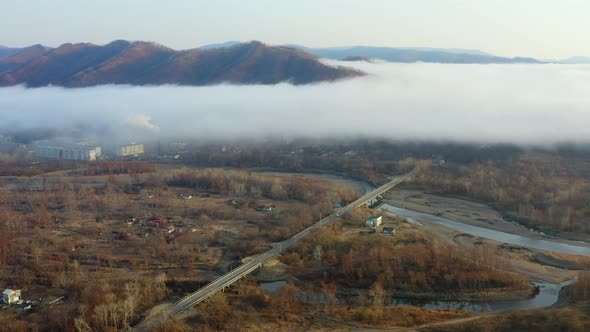 Flight Over the Valley Covered with Morning Mist in the Countryside