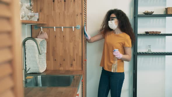 Girl Disinfects Furniture with a Sanitizer at Home.