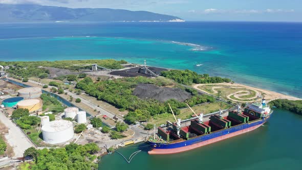 Loading Coal Into Dry Bulk Cargo Barge Docked At Ingenio Barahona In Dominican Republic. - aerial