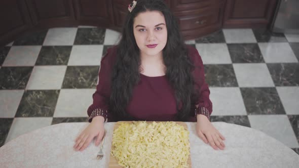 Top View Portrait of Confident Caucasian Fat Woman Ready To Eating Noodles. Plump Woman Prays Before