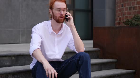 Young Designer Talking on Phone Negotiating in Good Mood