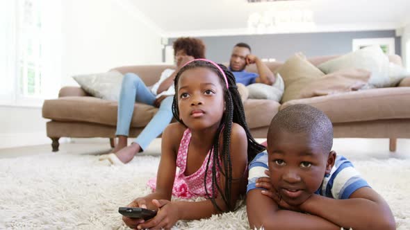 Children watching television in living room