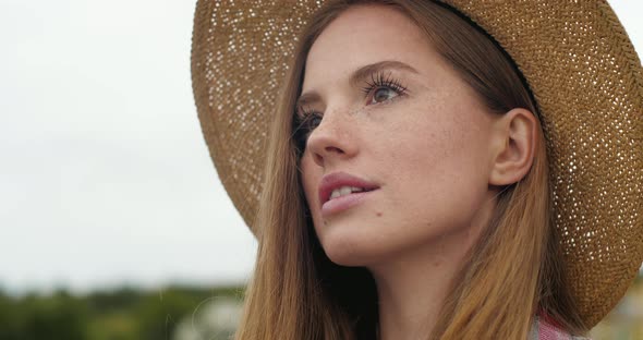 Portrait of Woman Pretty Face with Freckles opening eyes with Long Eyeslashes.