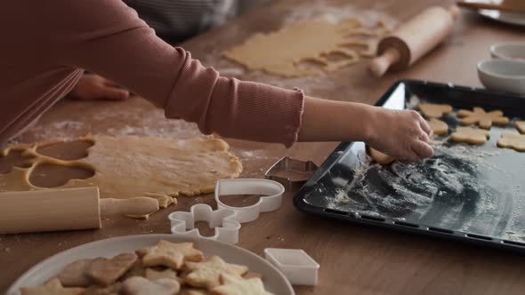 Caucasian girl cutting out homemade cookies with grandmother. Shot with RED helium camera in 8K