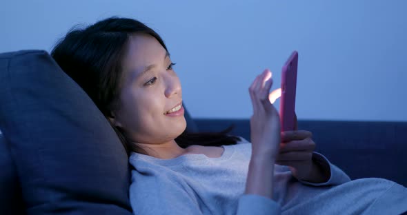 Woman working on cellphone at night