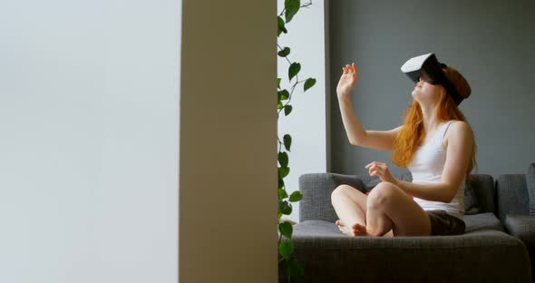 Woman using virtual reality headset in living room 4k