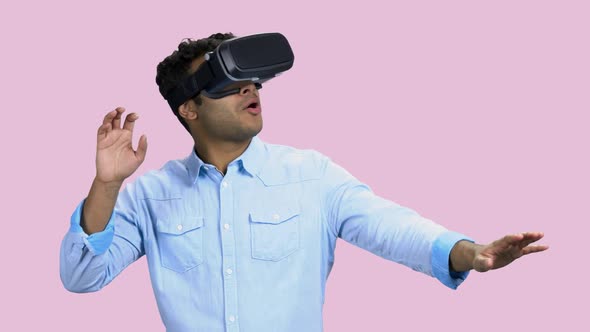 Young Scared Man Wearing Virtual Reality Goggles.