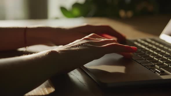 Close Up Woman Hands Scroll Three Times and Leave Frame on Laptop Computer Indoors