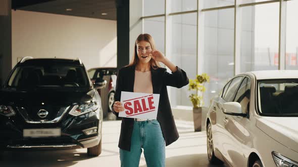 Smiling Caucasian Woman in Casual Clothes Standing at Modern Auto Salon and