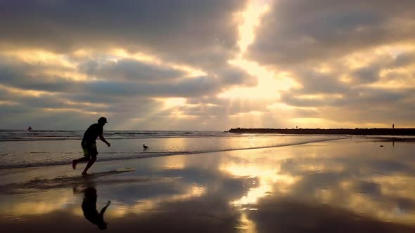 Two people running and jumping on skim boards